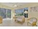 Relaxing sunroom featuring wicker furniture and sliding glass doors at 817 Montrose Dr # 103, Venice, FL 34293