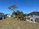 A spacious backyard with mature trees offers ample outdoor enjoyment at 874 Baveno Dr, Venice, FL 34285