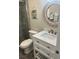 Bathroom featuring a modern vanity with a white countertop and decorative mirror at 874 Baveno Dr, Venice, FL 34285