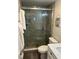 Bathroom with a tiled shower, pebble floor, and fresh towels at 874 Baveno Dr, Venice, FL 34285