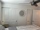 Bedroom featuring large closets, a ceiling fan, and a decorative mirror at 874 Baveno Dr, Venice, FL 34285