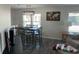 Dining area with table and chairs, modern light fixture, and windows for natural light at 874 Baveno Dr, Venice, FL 34285