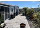 View of the yard showcasing the manicured patio, landscaping and the exterior of the single story home at 874 Baveno Dr, Venice, FL 34285