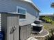 Exterior view of the home's storage and utility area featuring a craftsman style shed and air conditioning unit at 874 Baveno Dr, Venice, FL 34285