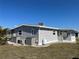 Side exterior showcasing well-maintained siding, landscaping, and outdoor equipment at 874 Baveno Dr, Venice, FL 34285