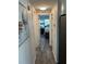 Hallway with wood flooring leading to a bedroom with a ceiling fan and natural light at 874 Baveno Dr, Venice, FL 34285