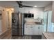 Renovated kitchen boasts stainless steel appliances, white cabinetry, and modern fixtures at 874 Baveno Dr, Venice, FL 34285