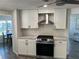 Updated kitchen featuring stainless steel appliances, white cabinets, and granite countertops at 874 Baveno Dr, Venice, FL 34285