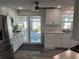 Bright kitchen features white cabinets, stainless steel appliances, and sliding glass doors to the patio at 874 Baveno Dr, Venice, FL 34285