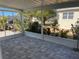 Bright screened-in lanai with outdoor seating and serene views of the surrounding lush greenery and landscaping at 874 Baveno Dr, Venice, FL 34285