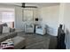 Open-concept living room with sofa, chairs and ceiling fan at 874 Baveno Dr, Venice, FL 34285