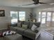 Comfortable living room featuring a sofa, accent pillows, and plenty of natural light at 874 Baveno Dr, Venice, FL 34285