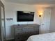 Bedroom featuring a flat screen TV and an attractive dresser with lots of storage at 874 Baveno Dr, Venice, FL 34285