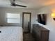 This bedroom features a window for lots of natural light and a wall-mounted flat screen TV at 874 Baveno Dr, Venice, FL 34285