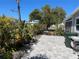 Paver patio surrounded by lush tropical landscaping provides an outdoor oasis at 874 Baveno Dr, Venice, FL 34285