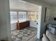Bright sunroom filled with natural light from multiple windows and a wooden dresser at 874 Baveno Dr, Venice, FL 34285