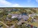 Aerial view of community clubhouse with golf course and pond at 1000 Joyce Ct, Venice, FL 34293