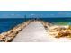 A couple strolls along a pier overlooking a calm ocean at 1000 Joyce Ct, Venice, FL 34293