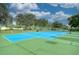 Blue tennis court with green perimeter at 1006 Gondola Park Dr # 1006, Venice, FL 34292