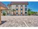 Parking area with brick pavers and building view at 101 Park S Blvd # 102, Venice, FL 34285