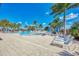 Pool area with lounge chairs and palm trees; great for relaxing at 10457 Crooked Creek Dr, Venice, FL 34293