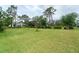 Large backyard with mature trees and plenty of green space at 1115 Oleander St, Englewood, FL 34223