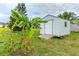 White storage shed with ramp access in grassy yard at 1115 Oleander St, Englewood, FL 34223