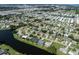 Aerial view of community with lake and houses at 1226 Pine Needle Rd, Venice, FL 34285