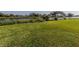 Spacious grassy backyard with canal view and lush landscaping at 1226 Pine Needle Rd, Venice, FL 34285