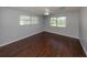 Spacious bedroom with wood-look floors and large windows at 1226 Pine Needle Rd, Venice, FL 34285