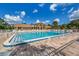 Sun-drenched community pool surrounded by lush landscaping at 1226 Pine Needle Rd, Venice, FL 34285