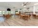 Bright community room with tables, chairs, and a TV at 1226 Pine Needle Rd, Venice, FL 34285