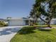 Ranch style home with a large tree in the front yard at 1226 Pine Needle Rd, Venice, FL 34285