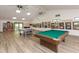 Game room with pool table, ping pong, and bookshelves at 1226 Pine Needle Rd, Venice, FL 34285