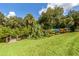 Many colorful kayaks are stored on a rack near a dock at 1226 Pine Needle Rd, Venice, FL 34285