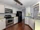 Updated kitchen with stainless steel appliances and wood flooring at 1226 Pine Needle Rd, Venice, FL 34285