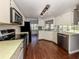 Modern kitchen, featuring stainless steel appliances and wood flooring at 1226 Pine Needle Rd, Venice, FL 34285