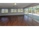 Spacious living area with dark wood floors and sliding doors to patio at 1226 Pine Needle Rd, Venice, FL 34285