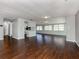 Large living room with dark hardwood floors and kitchen view at 1226 Pine Needle Rd, Venice, FL 34285