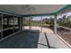 Relaxing screened porch with view of backyard and canal at 1226 Pine Needle Rd, Venice, FL 34285
