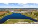 Aerial view of community with lake and golf course at 12280 Wellen Golf St # 108, Venice, FL 34293