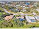 Aerial view of single-Gathering home with pool and lush landscaping in a residential neighborhood at 1237 Schooner Ln, Venice, FL 34285