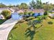 Single-Gathering home with a large yard, driveway, and palm trees at 1237 Schooner Ln, Venice, FL 34285