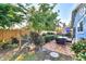 Landscaped backyard with patio, hammock, and wooden privacy fence at 1237 Schooner Ln, Venice, FL 34285