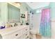 Bathroom with white vanity, a shower/tub combo and a colorful curtain at 1237 Schooner Ln, Venice, FL 34285