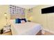 Bedroom with a queen bed and TV, featuring unique postcard wall art at 1237 Schooner Ln, Venice, FL 34285