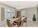 Sunlit dining room, featuring a wooden table and chandelier at 1237 Schooner Ln, Venice, FL 34285