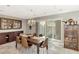 Elegant dining room featuring a wood table, chandelier, and built-in cabinetry at 1237 Schooner Ln, Venice, FL 34285