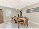 Bright dining room with a wood table, chandelier, and large window at 1237 Schooner Ln, Venice, FL 34285