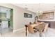 Spacious dining area with a large table, chandelier, and access to kitchen at 1237 Schooner Ln, Venice, FL 34285